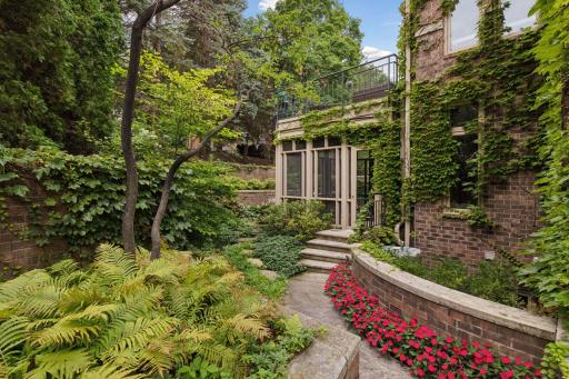 Winding landscaped paths surround this stunning property making it feel like a single family home.