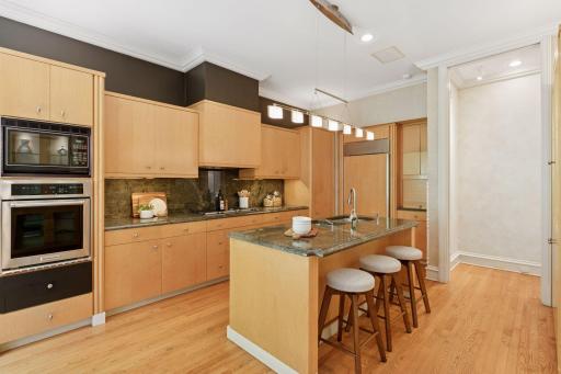 Gourmet kitchen with natural wood cabinetry.