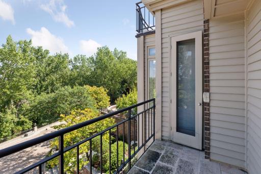 Double doors open to private balcony space.