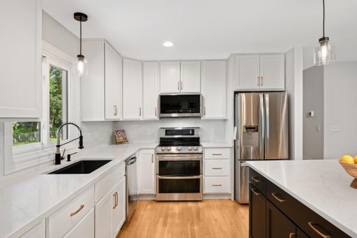 Double ovens and a convenient recycle center pull out garbage.