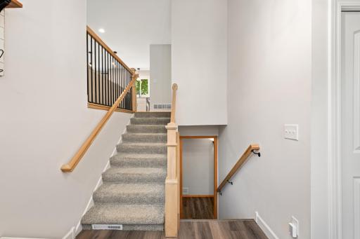 Beautiful new railing with shallow, gradual stairs leading to the upper level. Convenient coat closet in the entryway.