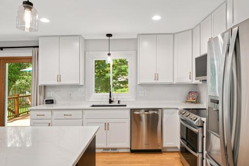 Huge black granite sink with kitchen window over-looking the backyard.