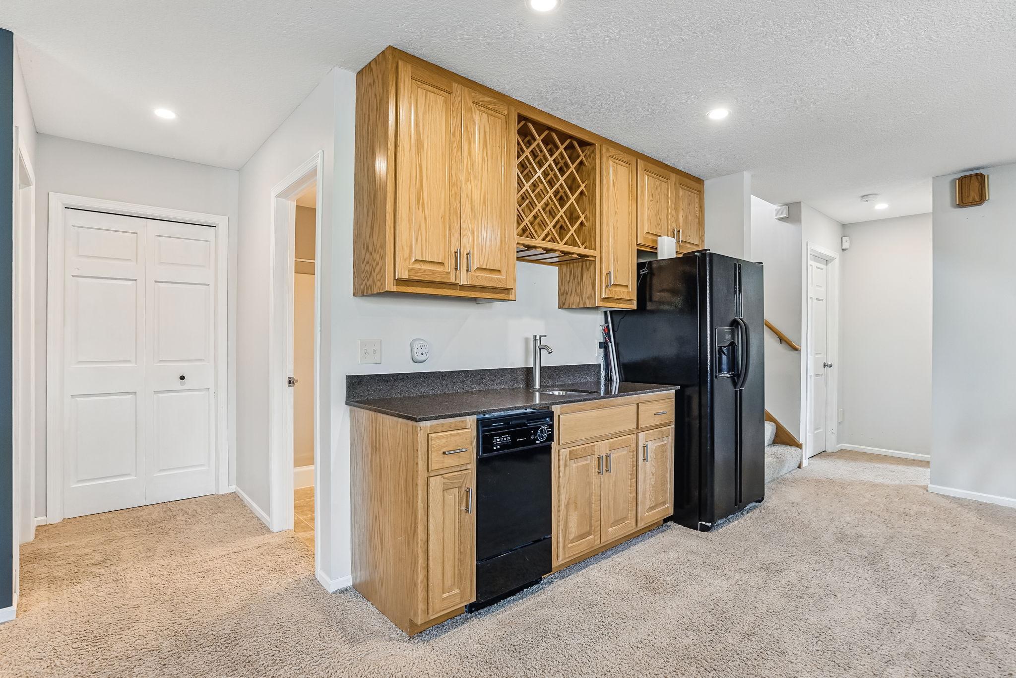 Lower level wet bar with dishwasher.