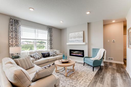 Large living room is perfect for gathering in. Photo of model home similar to new Henry plan, color & options will vary.