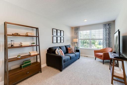 Oversized loft with windows overlooking the front of the home. Photo of model home similar to new Henry plan, color & options will vary.