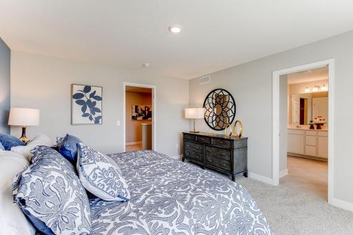 The home's primary suite is awesome and loaded - including immediate access to a private bath & is home to an oversized walk-in closet! Photo of model home similar to new Henry plan, color & options will vary.