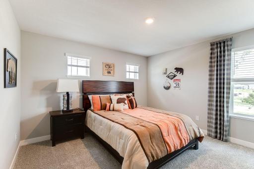 The third bedroom also features a walk-in closet! Photo of model home similar to new Henry plan, color & options will vary.