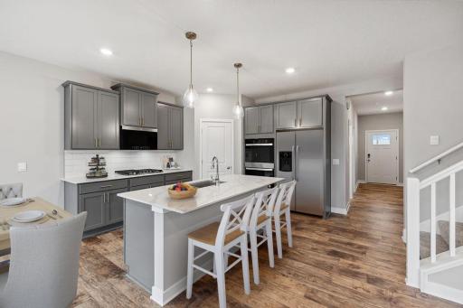 A stunning kitchen layout, all while remaining remarkably functional. Photo of a model home, color & options will vary.