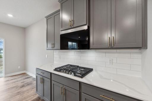 Kitchen has ample counter and cabinet space. The perfect space for making everyday meals or memorable special occasion dinners. Photo of a model home, color & options will vary.