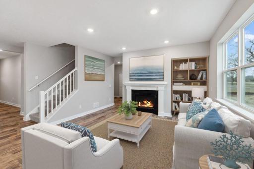 The open feel extends into to the main level family area - which is every bit as inviting and it is beautiful! Photo of a model home, color & options will vary.