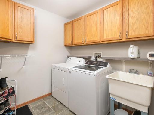 Main floor laundry with utility sink & even more built-in storage.
