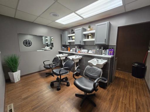 Back room area with 3 shampoo chairs & sink