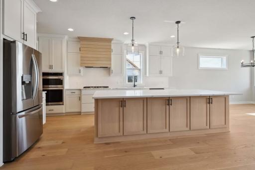Stunning kitchen includes 10' island, upper cabinets to ceiling, large walk-in pantry! Photos, virtual/video tours may not depict actual home. Features, materials & finishes shown may contain options that are not included in the price.