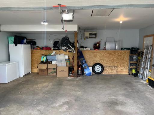2 car garage is HEATED! The chest freezer sellers are moving. Stand up freezer is for sale. Pull down the stairs in the ceiling and you will find a full attic storage area