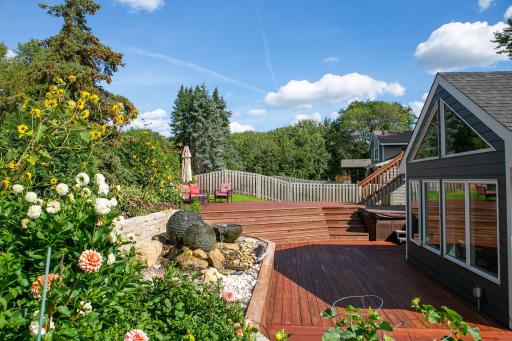Summer picture of the beautiful backyard that could be yours. There are the fountains, 3 deck spaces and a yard area on the side. EZ to maintain, private as you can get and totally fenced in.