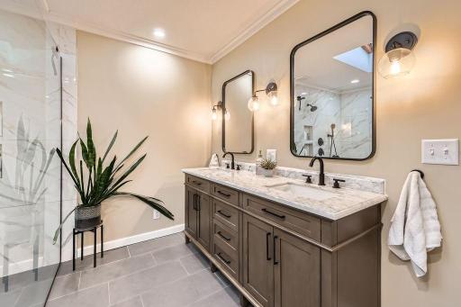 New double vanity, beautiful mirrors, updated lighting completes this stunning space