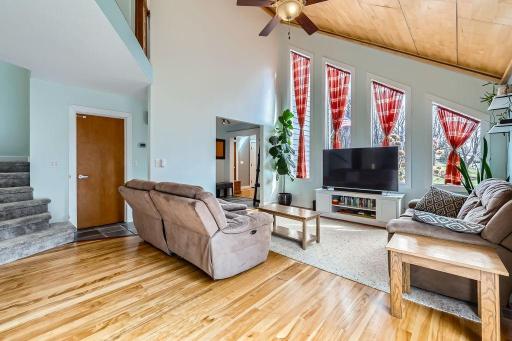 Natural light streaming in through the floor to ceiling windows compliment the beautiful hardwood floors on the main level