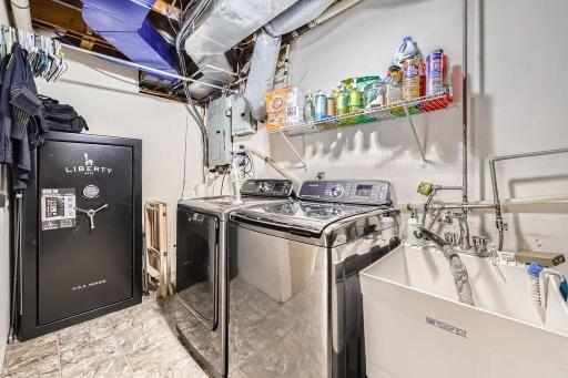 Laundry room has a beautiful set of washer & dryer that will be included in the sale of the home. Safe in the corner will be moved by the seller and not included in the sale
