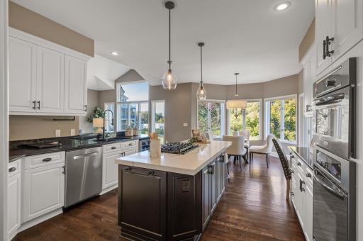 Highlights include a gas stovetop, Subzero fridge with custom cabinet front, brand-new wine fridge, and a built-in desk for added convenience.