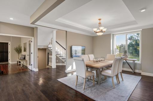 Just steps away from the kitchen, the formal dining room exudes elegance with front yard views and ample space for hosting gatherings.
