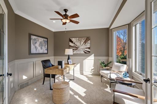 The main-level office features plush carpet, a beautiful bay window offering serene front yard views, and elegant crown moldingâperfect for a quiet workspace.