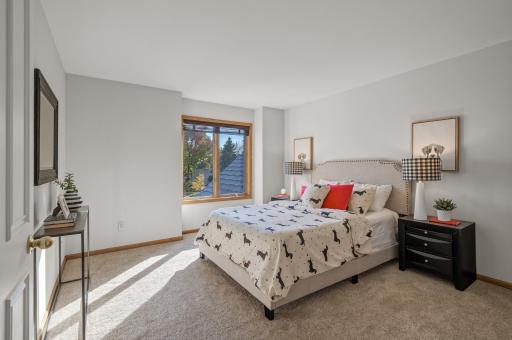 The upper level boasts two spacious bedrooms, each with an ensuite bathroom and walk-in closet.