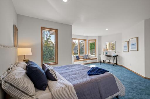 View of second bedroom on the upper level featuring a bay window with window bench.