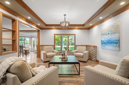 The tray ceiling in the lower-level recreation room adds a touch of sophistication, creating an inviting seating area for relaxing.