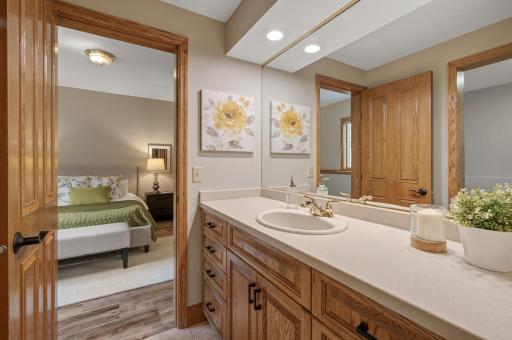Jack-and-Jill bathroom is equipped with a tub/shower combo.