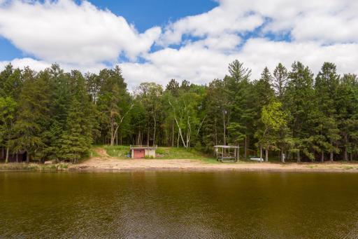 Upper Whitefish awaits, along with this rustic boathouse, grandfathered into the scenery here on the lake.