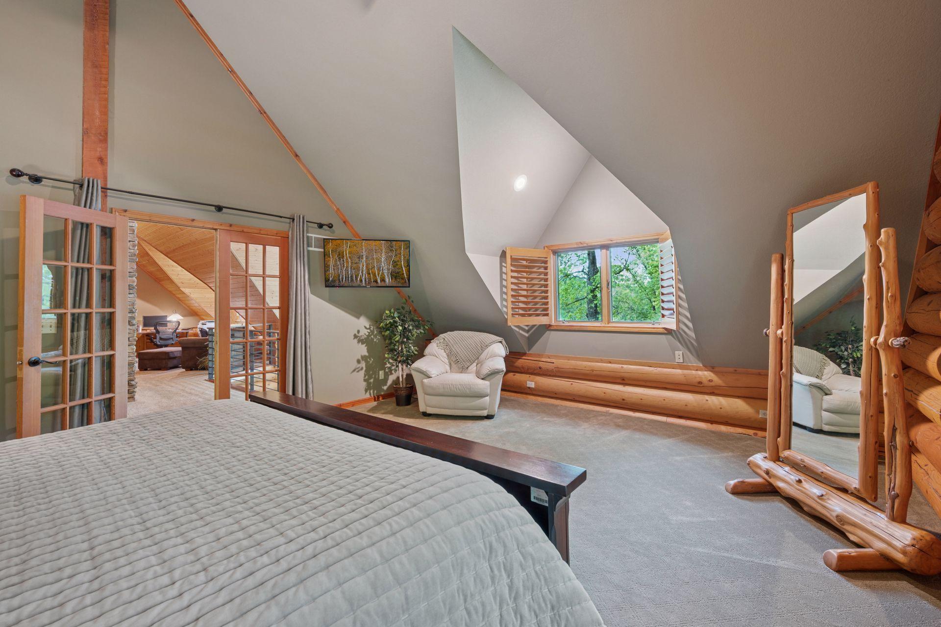 The upper-level primary bedroom is so spacious and able to accommodate all your large pieces of furniture.