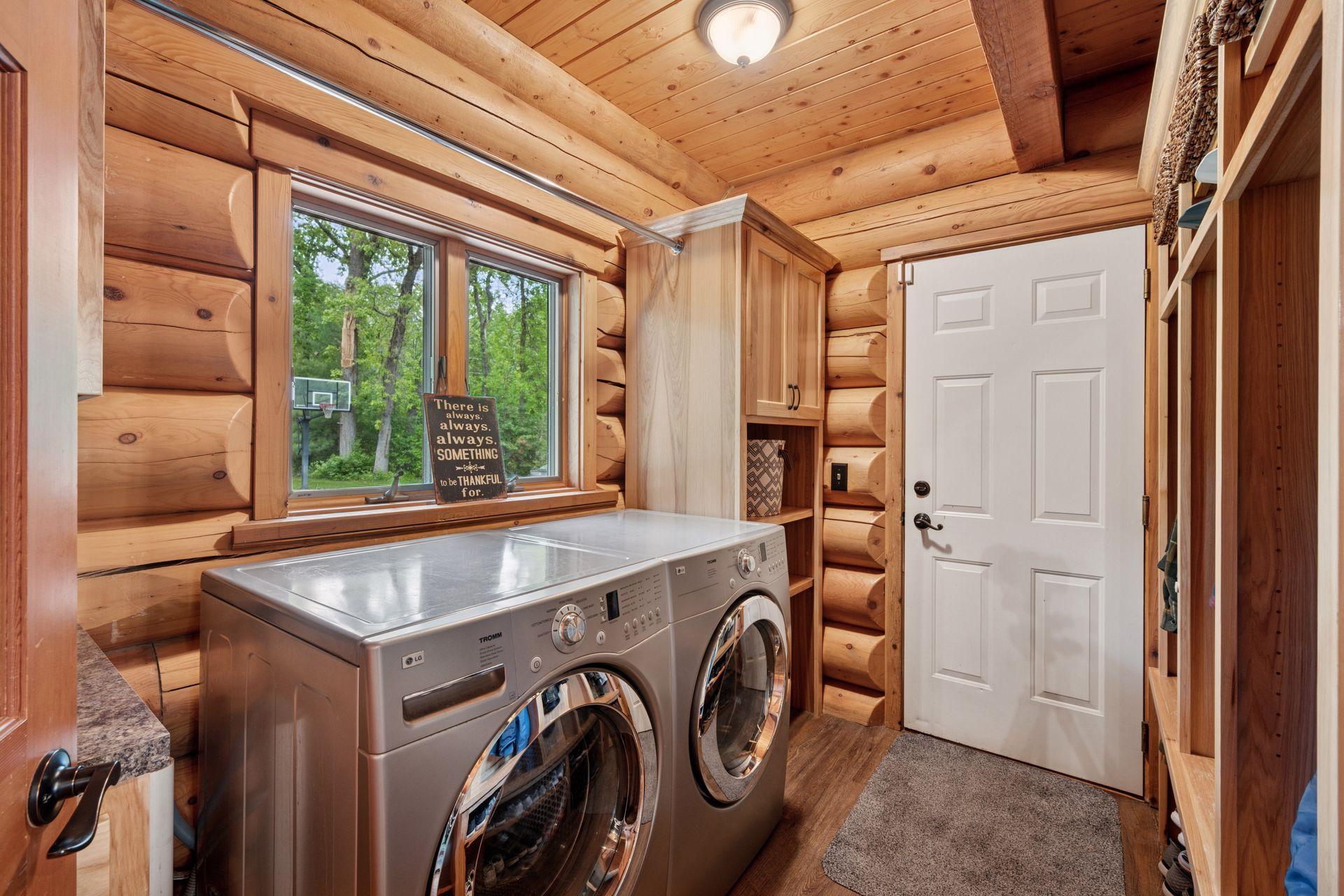 Main floor laundry with wall of built-in storage/locker system.
