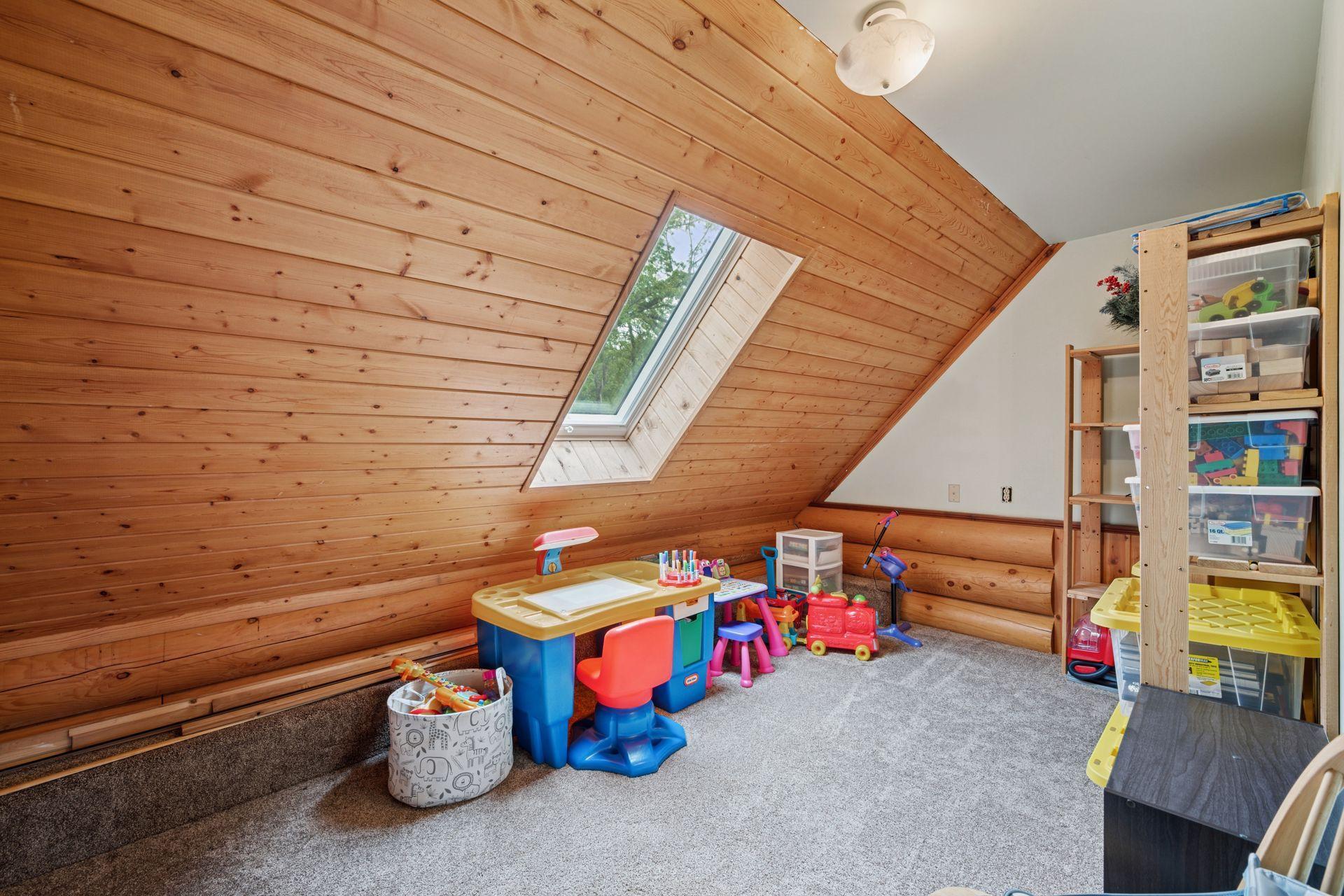 This upper level bedroom is currently set up as a playroom.