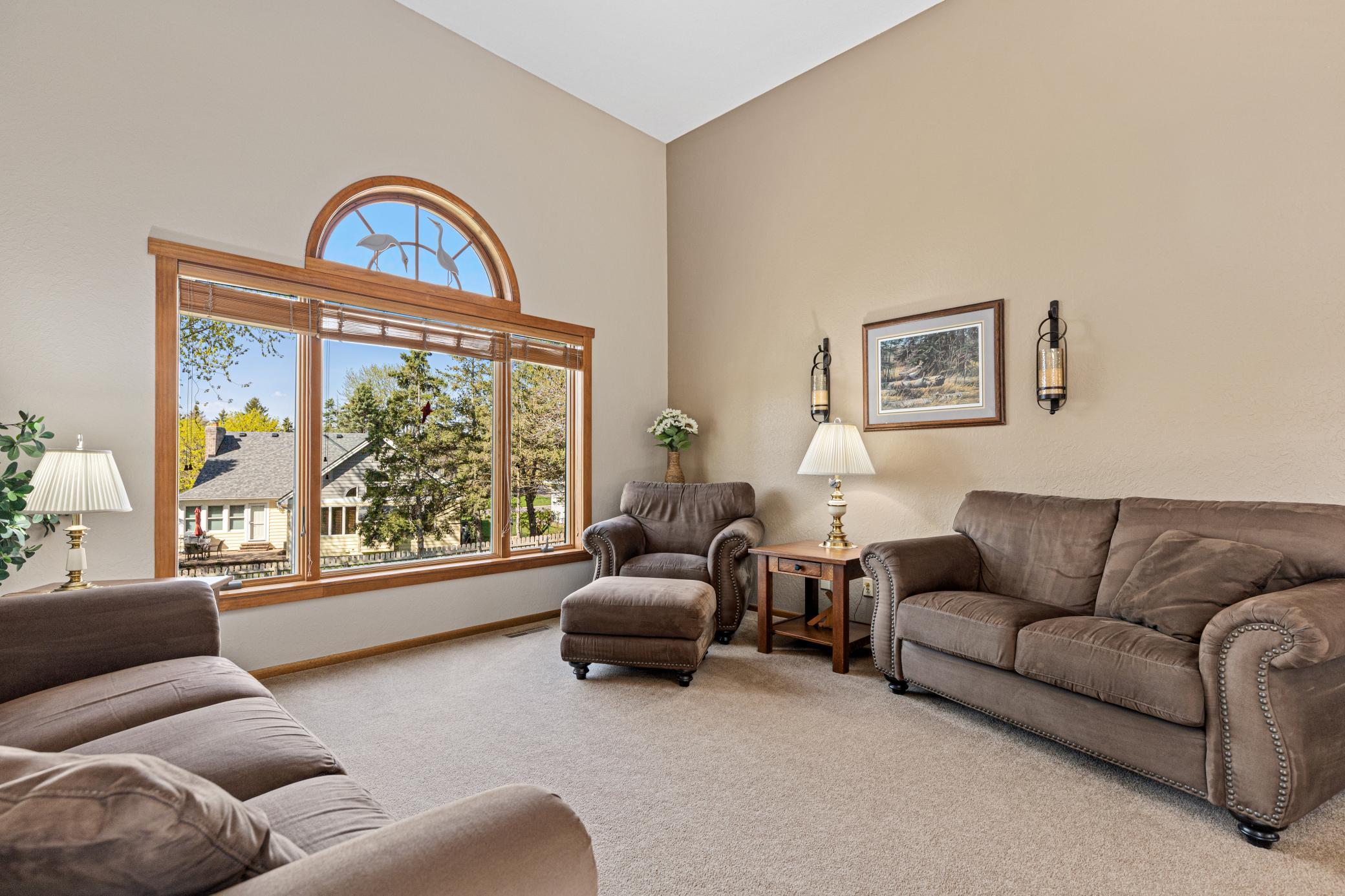 Sun-filled living room with soaring ceilings and a seamless, open feel