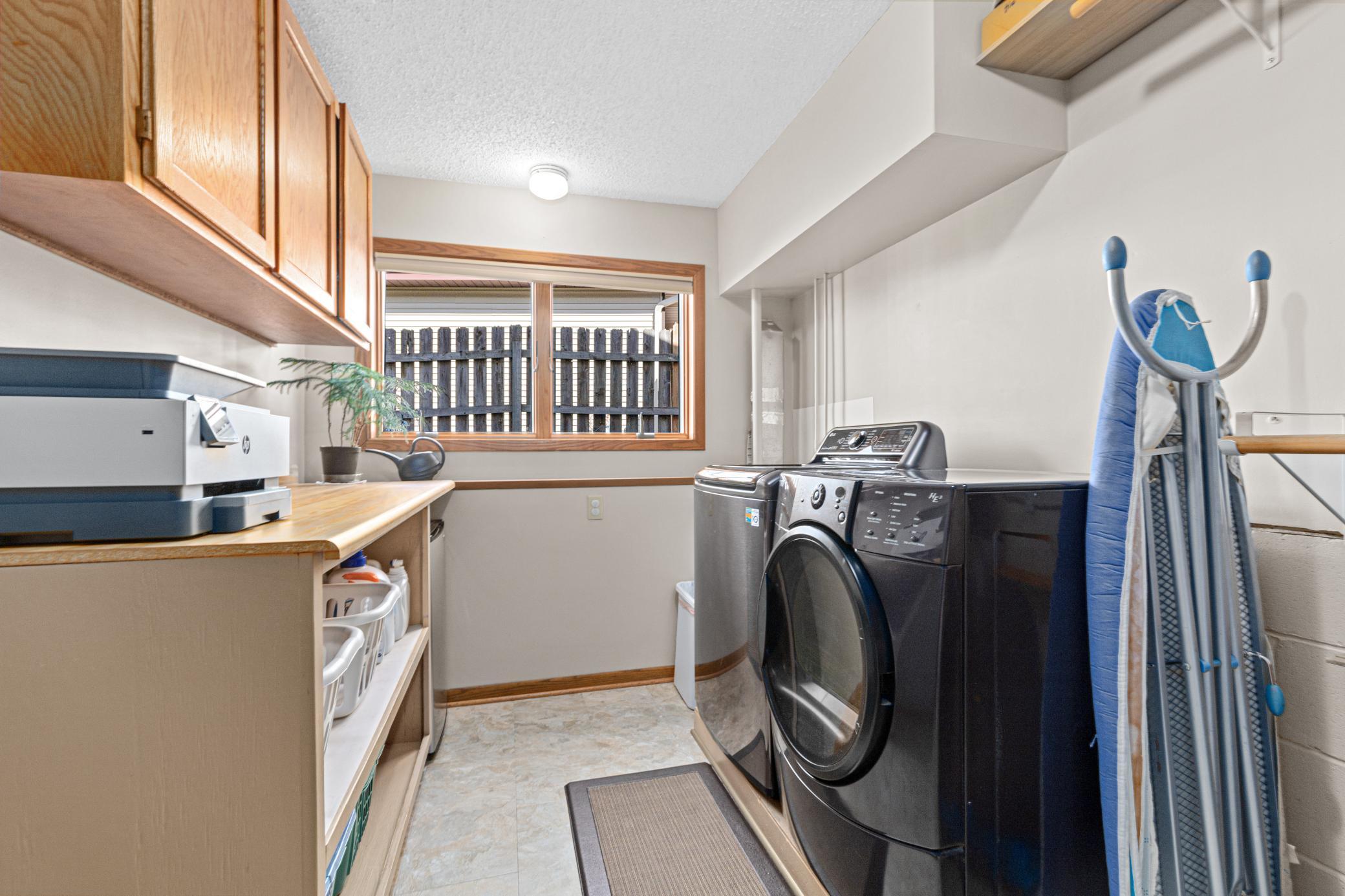 Spacious laundry room with cabinets and a window