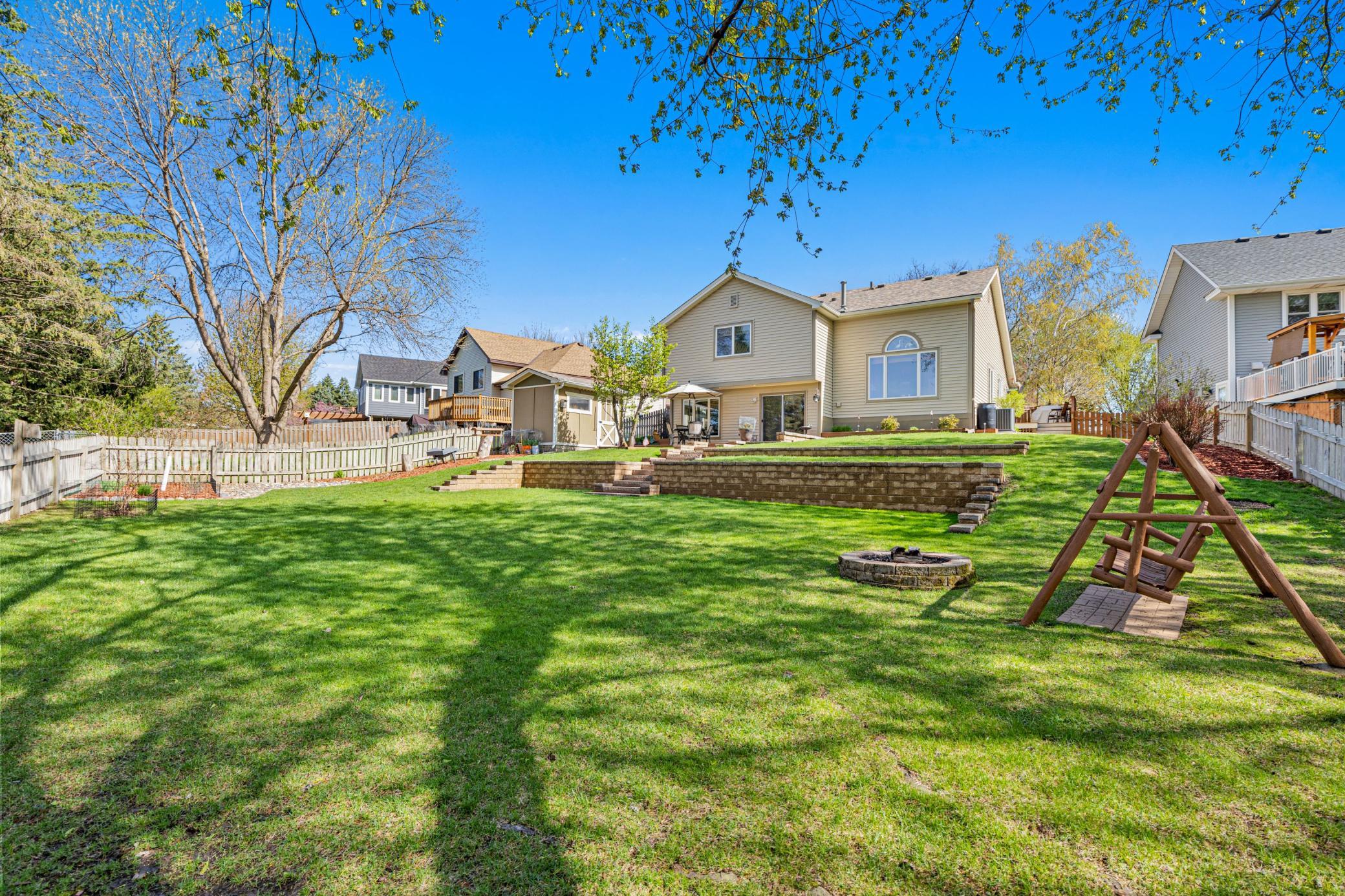 Lovingly landscaped expansive backyard with plenty of room to relax or play