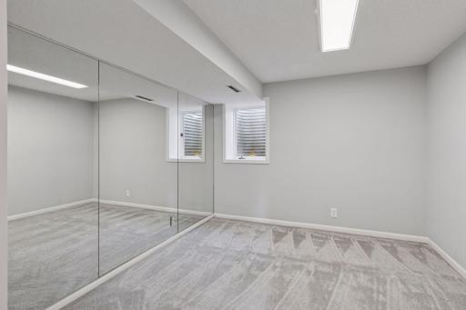 Lower level bedroom with egress window, new carpet and paint