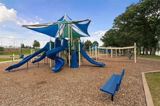 Parkers Lake offers playground, picnic shelters, swimming beach, ball fields and courts, tennis/pickleball, and paved trails