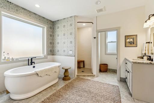Owners full bath with dual sinks, separate tub/shower. private water closet, in-floor heat, walk-in closet and laundry area.
