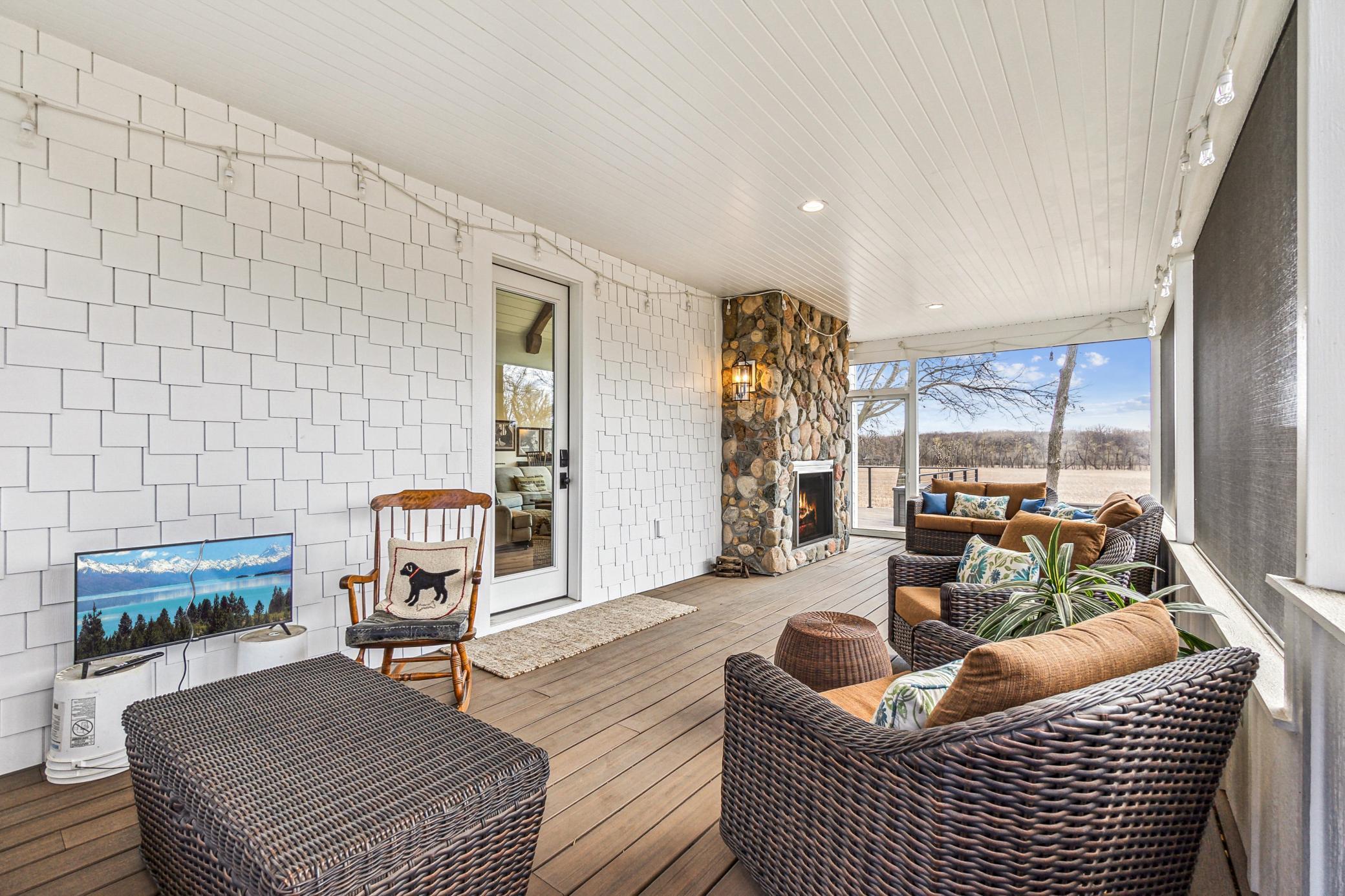 Three season porch with gas fireplace and mile long wetland views.