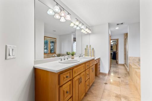 Large Primary bathroom with dual sink vanity and make-up station and a deep soaking tub with jets