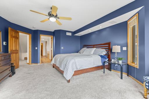 Relax in your primary suite after a long sunny day on the lake
