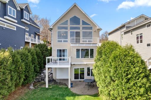 Back of the home facing the lake provides sparkling lake views and outdoor access on every level!