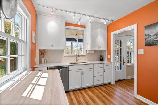 The updated kitchen shines with stainless steel appliances, quartz countertops, and sunny views of the backyard.