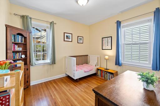 1 of 2 main floor bedroom with gorgeous original hardwood floors.