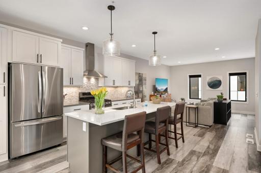 Mosaic slate tiled backsplash and stainless steel appliances