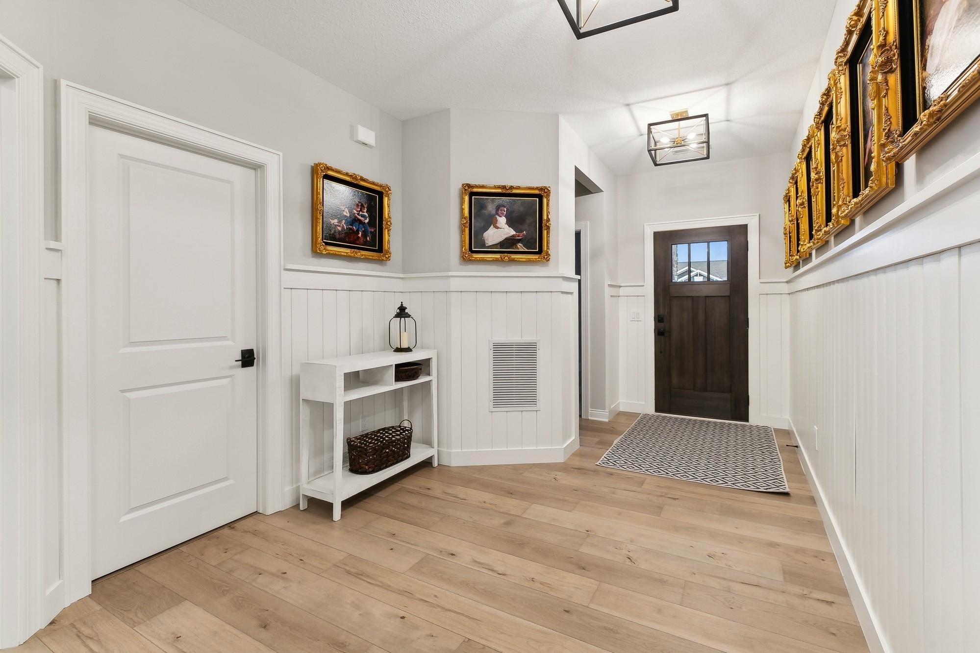 Entry foyer when you walk into the front door. Added in white ship lap wainscoting on the walls. Great addition.