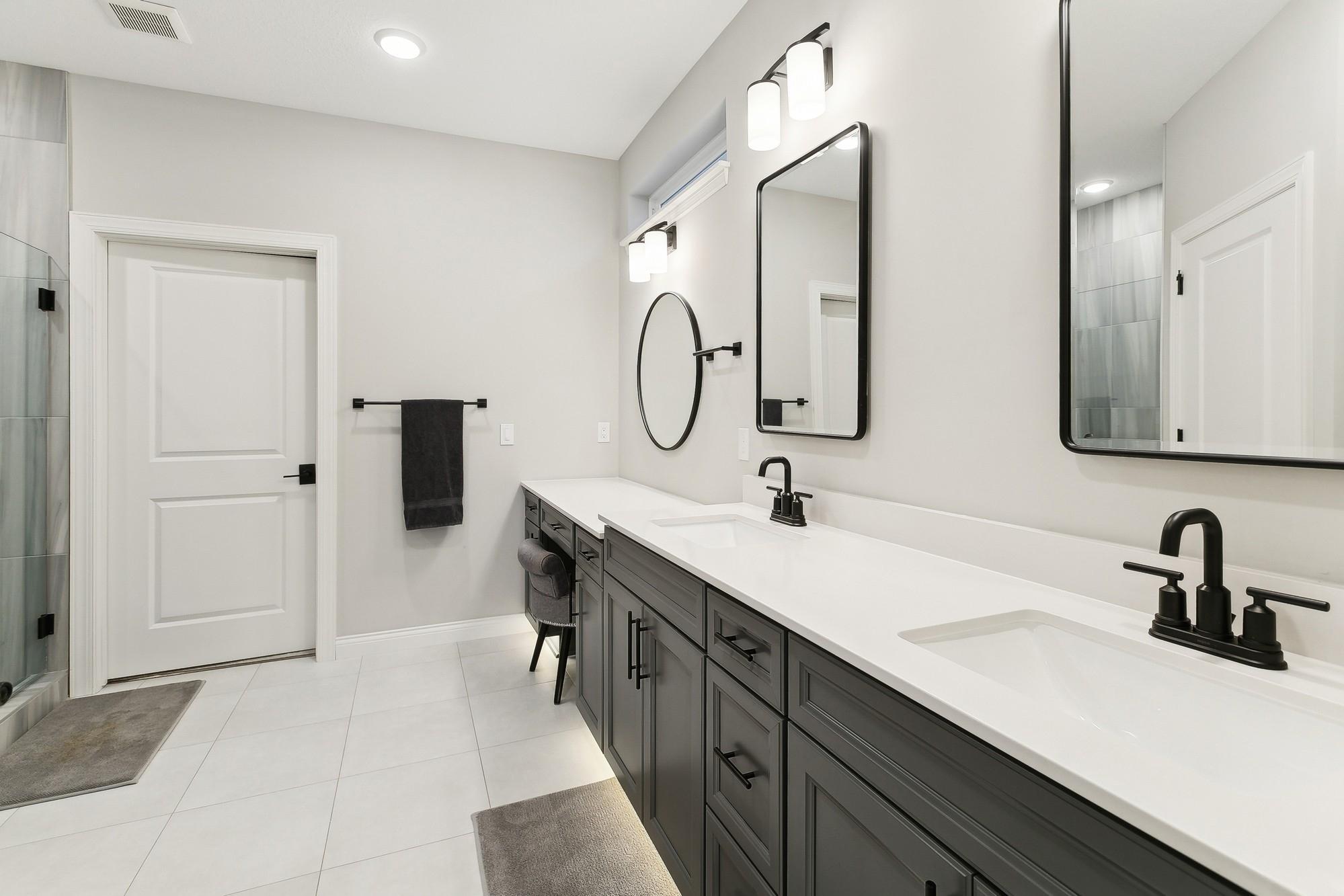 Double sinks in the primary bath along plus makeup vanity. Motion activated toe kick lighting is a bonus feature not to be missed!