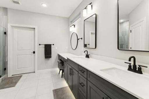Double sinks in the primary bath along plus makeup vanity. Motion activated toe kick lighting is a bonus feature not to be missed!