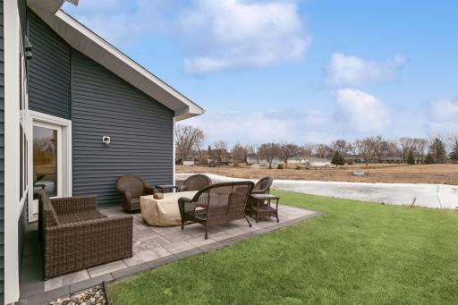Another angle of the oversized patio and scenic view. Great lot with a pond offers privacy in the rear.
